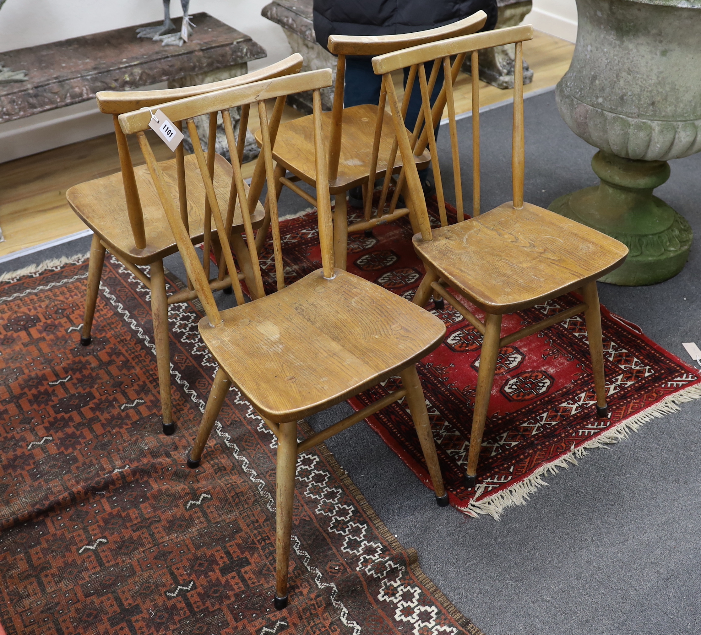 A set of four Ercol elm and beech fan back dining chairs